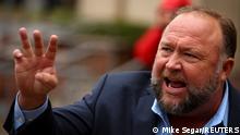 FILE PHOTO: Infowars founder Alex Jones speaks to the media after appearing at his Sandy Hook defamation trial at Connecticut Superior Court in Waterbury, Connecticut, U.S., October 4, 2022. REUTERS/Mike Segar/File Photo
