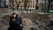 A couple kiss by a rocket crater in a park of central Kyiv A couple kiss by a rocket crater in a park of central Kyiv