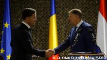 221012 -- CINCU ROMANIA, Oct. 12, 2022 -- Romanian President Klaus Iohannis R shakes hands with Dutch Prime Minister Mark Rutte at a news conference at a military training center in Cincu, central Romania, on Oct. 12, 2022. The Netherlands is not against Romania s accession to Schengen, visiting Prime Minister Mark Rutte said on Wednesday. Photo by /Xinhua ROMANIA-CINCU-PRESIDENT-THE NETHERLANDS-PM-MEETING CristianxCristel PUBLICATIONxNOTxINxCHN
