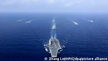 --FILE--In this aerial view, China's aircraft carrier, The Liaoning, of the PLA (People's Liberation Army) is followed by destroyers and frigates during a naval exercise in the western Pacific, 18 April 2018. The People's Liberation Army Navy has made tremendous strides over the past few years in transforming itself into a world-class force under guidance and instructions from President Xi Jinping, according to top Navy commanders. The PLA Navy was founded on April 23, 1949. To celebrate its 70th birthday, a host of multinational naval activities, including a joint sea parade, high-level symposiums and public tours of ships, are being held in Qingdao and nearby waters this week through Thursday (25 April 2019).