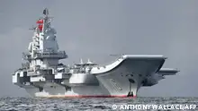 (FILES) In this file photo taken on July 7, 2017, China's aircraft carrier, the Liaoning, arrives in Hong Kong waters, less than a week after a high-profile visit by president Xi Jinping. - During Xi Jinping's decade-long rule China has built the world's largest navy, revamped the world's largest standing army and amassed a nuclear and ballistic arsenal to trouble any foe. (Photo by Anthony WALLACE / AFP)