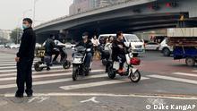 13.10.2022****
People ride scooters at an intersection near a bridge where social media videos earlier appeared to show smoke and protest banners in Beijing, Thursday, Oct. 13, 2022. China's internet censors moved quickly to scrub social media posts Thursday after reports of banners criticizing the Communist leadership being hung from a busy intersection in the capital Beijing. (AP Photo/Dake Kang)