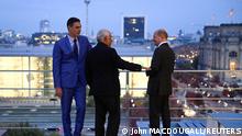 German Chancellor Olaf Scholz (R), Spanish Prime Minister Pedro Sanchez (L) and Portuguese Prime Minister Antonio Costa chat on the roof of the Chancellery prior to talks, as the city can be seen in the background, in Berlin on October 14, 2022. John MACDOUGALL/Pool via REUTERS