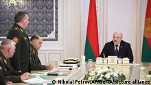 Belarusian President Alexander Lukashenko, right, attends a meeting with military top officials in Minsk, Belarus, Monday, Oct. 10, 2022. (Nikolai Petrov/BelTA Pool Photo via AP)