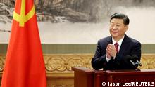 FILE PHOTO: Chinese President Xi Jinping claps after his speech as China's new Politburo Standing Committee members meet the press at the Great Hall of the People in Beijing, China October 25, 2017. REUTERS/Jason Lee/File Photo