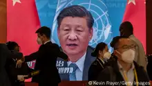 BEIJING, CHINA -OCTOBER 15: A video screen shows Chinese President Xi Jinping as security check visitors at the press centre for the 20th National Congress of the Communist Party of China in a closed loop hotel to prevent the spread of COVID-19 on October 15, 2022 in Beijing, China. The ruling Communist Party of China will open its 20th Party Congress on October 16th and Xi Jinping is widely expected to secure a third term in power. (Photo by Kevin Frayer/Getty Images)