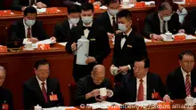Former Standing Committee member and Community Party elder Song Ping drinks from a cup during the opening ceremony of the 20th National Congress of China's ruling Communist Party held at the Great Hall of the People in Beijing, China, Sunday, Oct. 16, 2022. China on Sunday opens a twice-a-decade party conference at which leader Xi Jinping is expected to receive a third five-year term that breaks with recent precedent and establishes himself as arguably the most powerful Chinese politician since Mao Zedong. (AP Photo/Mark Schiefelbein)