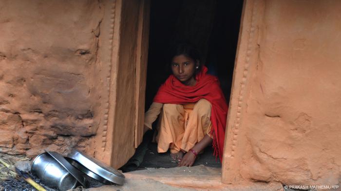 A Nepalese villager sits inside a 'chhaupadi house' in the village of Achham, some 800 km (497 miles) west of Kathmandu