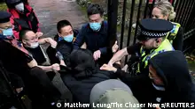 A man is pulled at the gate of the Chinese consulate after a demonstration against China's President Xi Jinping, in Manchester, Britain October 16, 2022. Matthew Leung/The Chaser News/Handout via REUTERS ATTENTION EDITORS - THIS IMAGE WAS PROVIDED BY A THIRD PARTY. NO RESALES. NO ARCHIVES.