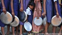 Indian schoolchildren wait in line for their mid-day meal at a government primary school in the outskirts of Hyderabad on June 13, 2011, on the opening day of the new academic year. The government of India's Andhra Pradesh state has introduced English as a second language from Class 1 onwards for the 2011-2012 academic year. India's National Knowledge Commission has admitted that no more than one percent of country's population uses English as a second language. AFP PHOTO/Noah SEELAM (Photo by Noah SEELAM / AFP) (Photo by NOAH SEELAM/AFP via Getty Images)