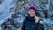 Holly Zimmermann standing in the Himalayan mountains, dressed in warm clothing and smiling Holly Zimmermann standing in the Himalayan mountains, dressed in warm clothing and smiling