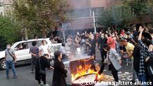 October 20, 2022, Tehran, Iran: A picture obtained by ZUMA outside Iran, reportedly shows protesters set fire as they clash with police during a protest over the death of young Iranian woman Mahsa Amini, who died on 16 September after being arrested in Tehran for not wearing her hijab appropriately in the capital Tehran on September 19, 2022. Iran has been facing worldwide anti-government protests following the death of Masha Amini, a 22-year-old girl, who was detained on 13 September by the police unit responsible for enforcing Iran's strict dress code for women. Amini was declared dead on 16 September, after she spent 3 days in a coma. According to the police, she fell into a coma and died of heart failure, while her family says that she had no prior health conditions. Her death has triggered protests in various areas in Iran and around the world. Iran has been torn by the biggest wave of social unrest in almost three years, which has seen protesters, including university students and even young schoolgirls chant ''Woman, Life, Freedom''. Iranian leaders condemned the protests as 'riots' and accused US and Israel of planning the protests inside the country. According to Iran's state news agency IRNA, Iranian President Ebrahim Raisi expressed his sympathy to the family of Amini on a phone call and assured them that her death will be investigated carefully. Chief Justice of Iran Gholam-Hossein Mohseni-Eje'i assured her family that upon its conclusion, the investigation results by the Iranian Legal Medicine Organization will be announced without any special considerations