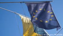 FILE PHOTO: The flag of the European Union and Ukraine's national flag fly at a building in Bern, Switzerland September 19, 2022. REUTERS/Arnd Wiegmann/File Photo