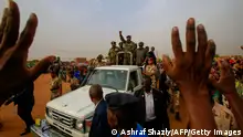 General Abdel Fattah al-Burhan, the head of Sudan's ruling military council, greets his supporters upon his arrival to a rally in Khartoum's twin city of Omdurman on June 29, 2019. - Burhan, told a rally in Omdurman, the twin city of Khartoum, that the generals were ready to give up power. We promise you that we will reach an agreement fast with our brothers in the Alliance for Freedom and Change and other political groups, he said. We are ready to cede power today to an elected government that is acceptable to all the people of Sudan. (Photo by ASHRAF SHAZLY / AFP) (Photo credit should read ASHRAF SHAZLY/AFP via Getty Images)