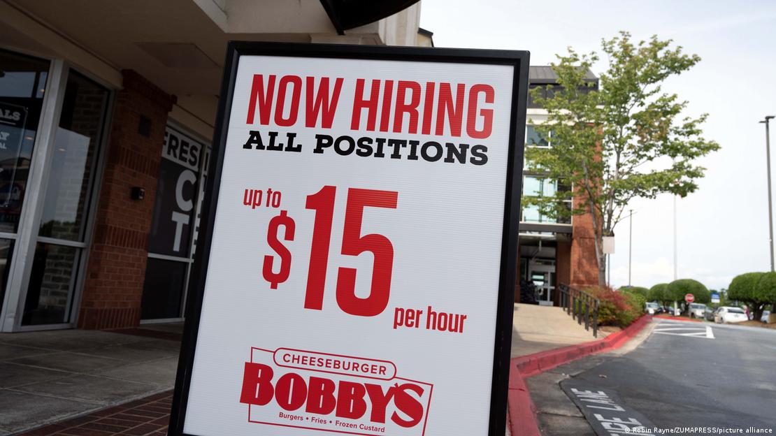 A hamburger restaurant advertises it is hiring for all positions on August 23, 2022 in Woodstock, Georgia, USA
