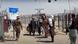 A group of pedestrians move through the wire-fenced border crossing of Chaman A group of pedestrians move through the wire-fenced border crossing of Chaman