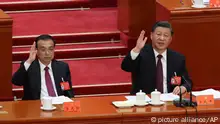 China's Premier Li Keqiang, and President Xi Jinping raise their hands to vote during the National Congress of the Chinese Communist Party, NCCCP, in Beijing, China on Oct. 22, 2022.( The Yomiuri Shimbun via AP Images )
