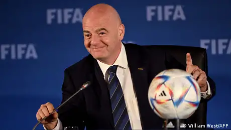 Gianni Infantino has his hand on a soccer ball