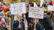 Protesters in a crowd in Berlin on October 22, 2022, holding signs Protesters in a crowd in Berlin on October 22, 2022, holding signs