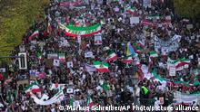 People attend a protest against the Iranian regime, in Berlin, Germany, Saturday, Oct. 22, 2022, following the death of Mahsa Amini in the custody of the Islamic republic's notorious morality police. The 22-year-old died in Iran while in police custody on Sept. 16 after her arrest three days prior for allegedly violating its strictly-enforced dress code. (AP Photo/Markus Schreiber)