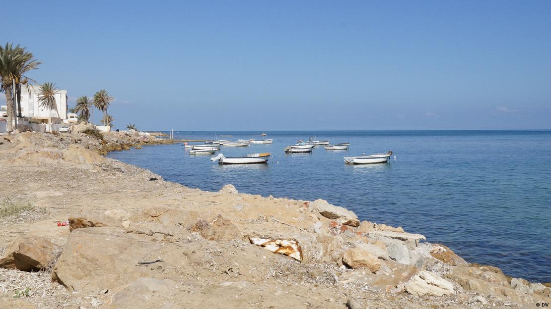 Small boats float in water off the coast in Tunisia. 