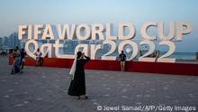 Visitors take photos with a FIFA World Cup sign in Doha on October 23, 2022, ahead of the Qatar 2022 FIFA World Cup football tournament. (Photo by Jewel SAMAD / AFP) (Photo by JEWEL SAMAD/AFP via Getty Images)