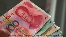 April 19, 2022, Lima, Lima, Peru: Chinese Yuan banknotes, showing the printed portrait of Mao zeDong, held in a hand. The Yuan is the base unit of the Renminbi, the legal tender of the People's Republic of China issued by the People's Bank of China. (Credit Image: Â© Carlos Garcia Granthon/ZUMA Press Wire