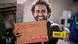A man holds signs and placards as he stands with supporters during a protest calling for his release A man holds signs and placards as he stands with supporters during a protest calling for his release