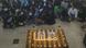 Candles surrounding photos of Jina Mahsa Amini with students sitting nearby