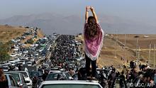 This UGC image posted on Twitter reportedly on October 26, 2022 shows an unveiled woman standing on top of a vehicle as thousands make their way towards Aichi cemetery in Saqez, Mahsa Amini's home town in the western Iranian province of Kurdistan, to mark 40 days since her death, defying heightened security measures as part of a bloody crackdown on women-led protests. - A wave of unrest has rocked Iran since 22-year-old Amini died on September 16 following her arrest by the morality police in Tehran for allegedly breaching the country's strict rules on hijab headscarves and modest clothing. (Photo by UGC / AFP) / Israel OUT - NO Resale / XGTY/RESTRICTED TO EDITORIAL USE - MANDATORY CREDIT AFP - SOURCE: ANONYMOUS - NO MARKETING - NO ADVERTISING CAMPAIGNS - NO INTERNET - DISTRIBUTED AS A SERVICE TO CLIENTS - NO RESALE - NO ARCHIVE -NO ACCESS ISRAEL MEDIA/PERSIAN LANGUAGE TV STATIONS OUTSIDE IRAN/ STRICTLY NO ACCESS BBC PERSIAN/ VOA PERSIAN/ MANOTO-1 TV/ IRAN INTERNATIONAL/RADIO FARDA - AFP IS NOT RESPONSIBLE FOR ANY DIGITAL ALTERATIONS TO THE PICTURE'S EDITORIAL CONTENT /