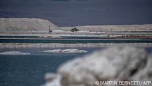 View of brine ponds and processing areas of the lithium mine of the Chilean company SQM (Sociedad Quimica Minera) in the Atacama Desert, Calama, Chile, on September 12, 2022. - The turquoise glimmer of open-air pools meets the dazzling white of a seemingly endless salt desert where hope and disillusionment collide in Latin America's lithium triangle. A key component of batteries used in electric cars, demand has exploded for the white gold found in Argentina, Bolivia and Chile in quantities larger than anywhere else in the world. (Photo by Martin BERNETTI / AFP)