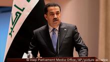 This photo provided by Iraqi Parliament Media Office, shows Mohammed Shia al-Sudani, a candidate for Iraq's prime minister position, speaks during the parliamentary session to vote on the new government in Baghdad, Iraq, Thursday, Oct.27, 2022. (Iraqi Parliament Media Office via AP)