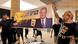 Men in T-shirts hold up banner showing grey-haired man in suit, tie, slogan in Hebrew Men in T-shirts hold up banner showing grey-haired man in suit, tie, slogan in Hebrew