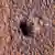 El cráter se formó el 24 de diciembre de 2021, cuando un meteoroide golpeó el suelo en una región de Marte llamada Amazonis Planitia.