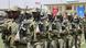 Soldiers with guns on their shoulders, with a Somali and Turkish flag in the background Soldiers with guns on their shoulders, with a Somali and Turkish flag in the background