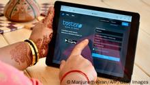 A woman browses through the login page of 'Tooter', a social network modelled after the popular 'Twitter', on a handheld tablet device, in Bangalore on November 30, 2020. (Photo by Manjunath Kiran / AFP) (Photo by MANJUNATH KIRAN/AFP via Getty Images)