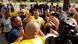 Bolsonaro, surrounded by security, waves at his supporters in front of a polling station in Rio de Janeiro 