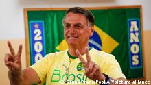 Brazilian President Jair Bolsonaro, who is running for another term, makes the victory sign before voting in a second round presidential election in Rio de Janeiro, Brazil, Sunday, Oct. 30, 2022. (AP Photo/Bruna Prado, Pool)