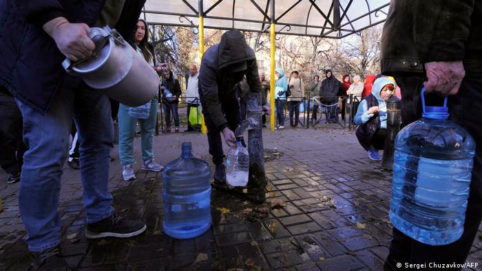 Les habitants de Kyiv tirent de l'eau d'une pompe dans un parc à Kyiv