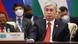 Tokayev, in a dark suit and red tie, sits behind a desk at a summit meeting Tokayev, in a dark suit and red tie, sits behind a desk at a summit meeting