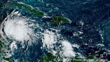 This satellite image taken at 8:40am ET and provided by NOAA shows Tropical Storm Lisa under Cuba in the Caribbean Sea, Tuesday, Nov. 1, 2022. Lisa is forecast to make landfall in Central America later in the week as a likely hurricane. (NOAA via AP)