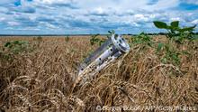 TOPSHOT - A fragment of a rocket from a multiple rocket launcher is seen embedded in the ground on a wheat field in the Ukrainian Kharkiv region on July 19, 2022, amid Russian invasion of Ukraine. - Russia and Ukraine on July 22, 2022 signed a landmark deal with the United Nations and Turkey on resuming grain shipments that could ease a global food crisis in which millions face hunger. (Photo by SERGEY BOBOK / AFP) (Photo by SERGEY BOBOK/AFP via Getty Images)