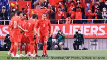 Chinese team shows a solidarity ahead of the FIFA Asian World Cup Qualifier against Japan at Saitama Stadium on Jan. 27, 2022. ( The Yomiuri Shimbun via AP Images )