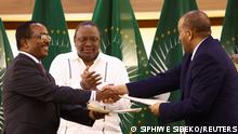 Former Kenyan President Uhuru Kenyatta applauds Ethiopian government representative Redwan Hussien and Tigray delegate Getachew Reda after signing the AU-led negotiations to resolve the conflict in northern Ethiopia, in Pretoria, South Africa, November 2, 2022. REUTERS/Siphiwe Sibeko 