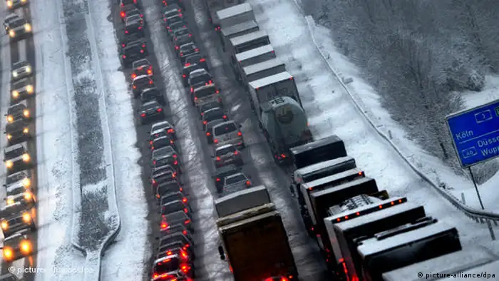 Cars and trucks queue up along a motorway outside of Cologne in Germany. Photo: Julian Stratenschulte dpa/lnw