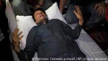 In this photo released by former Pakistani Prime Minister Imran Khan's party, Pakistan Tehreek-e-Insaf, Imran Khan, who injured in a shooting incident, is seen after the incident, in in Wazirabad, Pakistan, Thursday, Nov. 3, 2022. A gunman opened fire at a campaign truck carrying Khan on Thursday, wounding him slightly and also some of his supporters, a senior leader from his party and police said. (Pakistan Tehreek-e-Insaf via AP)