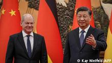 Chinese President Xi Jinping (R) welcomes German Chancelor Olaf Scholz at the Grand Hall in Beijing on November 4, 2022. (Photo by Kay Nietfeld / POOL / AFP)
