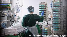 A nurse takes care of a Covid-19 patient in the Covid-19 intensive care unit of the university hospital (Universitaetsklinikum) in Essen, western Germany, on March 22, 2021, amid the novel coronavirus / COVID-19 pandemic. (Photo by Ina FASSBENDER / AFP) (Photo by INA FASSBENDER/AFP via Getty Images)