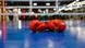 A pair of red leather boxing gloves sit on the floor of a boxing ring A pair of red leather boxing gloves sit on the floor of a boxing ring