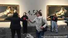 This handout picture released by Extinction Rebellion environmental movement on November 5, 2022 shows two activists glued by a hand to the frames of two paintings by Spanish master Francisco Goya at the Prado museum in Madrid. - The protesters scrawled +1,5°C on the wall between the two artworks in reference to the Paris Agreement target of capping warming at 1.5 degrees Celsius above pre-industrial levels. Both activists were detained, police said. (Photo by Extinction Rebellion / AFP) / RESTRICTED TO EDITORIAL USE - MANDATORY CREDIT AFP PHOTO / Extinction Rebellion - NO MARKETING NO ADVERTISING CAMPAIGNS - DISTRIBUTED AS A SERVICE TO CLIENTS